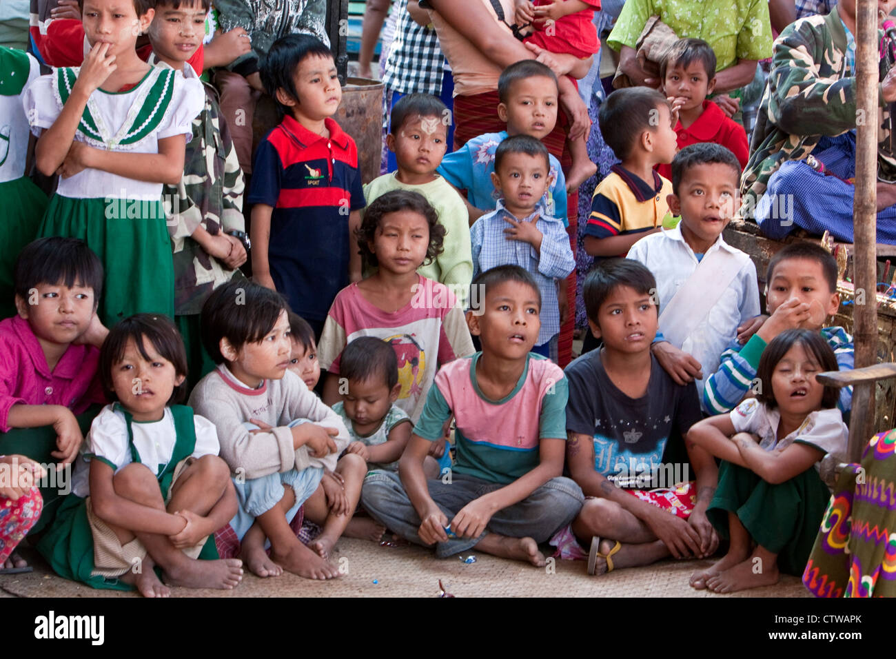 Myanmar, Burma. Bagan. Burmese Children Watching a Nat Pwe Celebration, thanking the spirits for a year of good fortune. Stock Photo