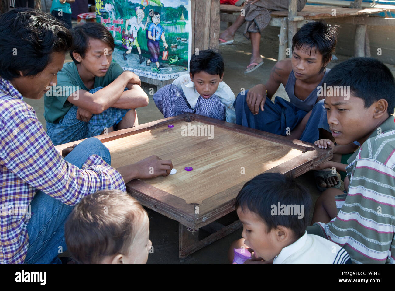 Myanmar, Burma. Bagan. Young Men Playing a Board Game. Stock Photo