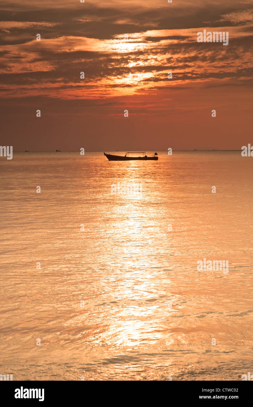 a boat on the sea at sunset in thailand Stock Photo - Alamy