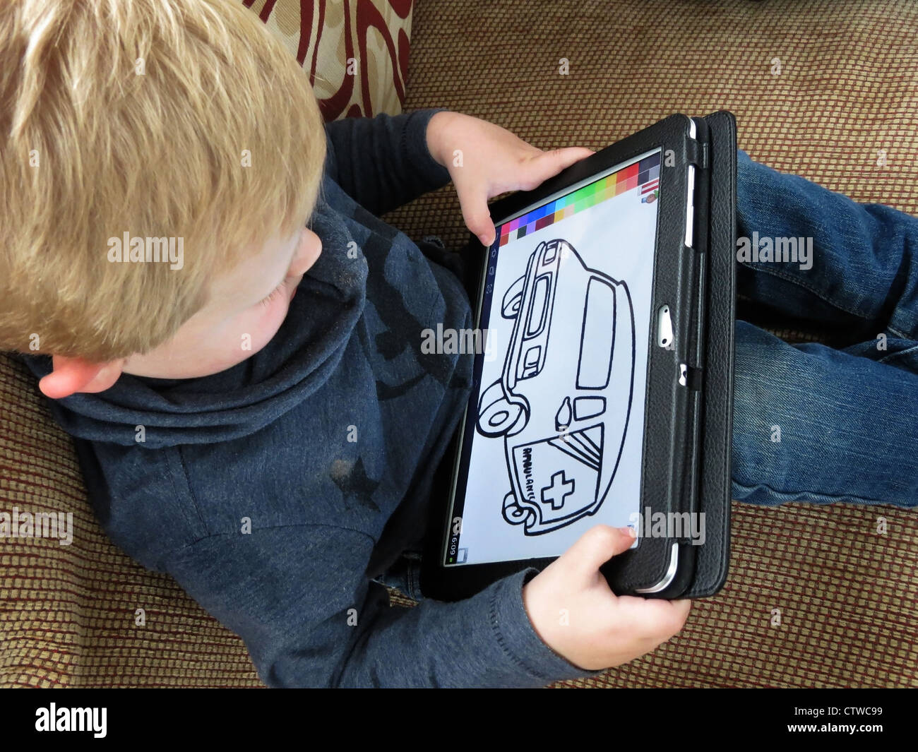 Child using tablet computer. Stock Photo