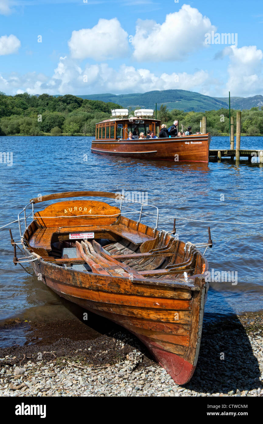 Tourists on a ferry with rowing boat in the foreground on Derwentwater, Keswick in the Lake District, Cumbria Stock Photo
