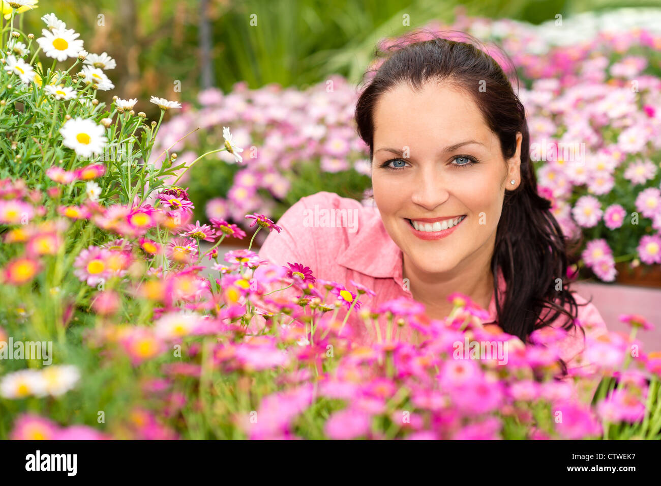 Portrait beautiful woman with purple daisy flowers in garden center