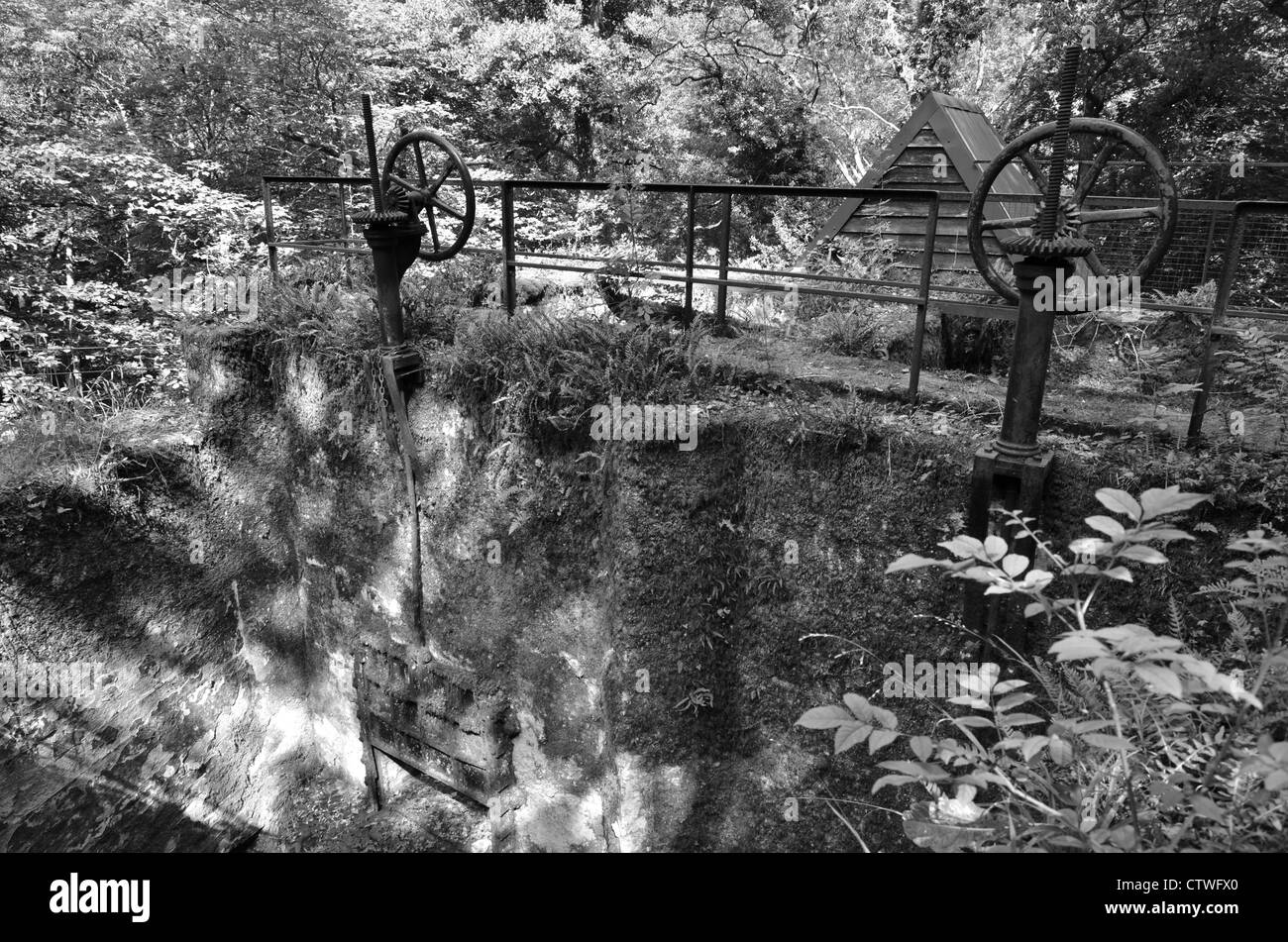 Holding pool and sluice controls at the old hydroelectric power station, River Teign, Devon, which used to supply Castle Drogo. Stock Photo