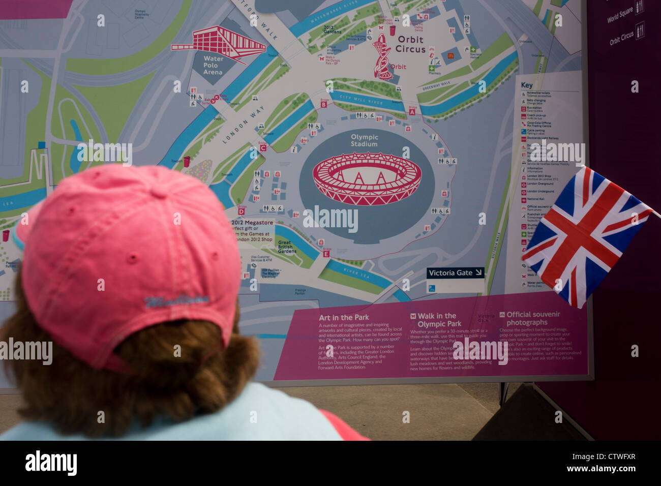 Spectators consult a detailed map of the Olympic Park during the London 2012 Olympics. This land was transformed to become a 2.5 Sq Km sporting complex, once industrial businesses and now the venue of eight venues including the main arena, Aquatics Centre and Velodrome plus the athletes' Olympic Village. After the Olympics, the park is to be known as Queen Elizabeth Olympic Park. Stock Photo