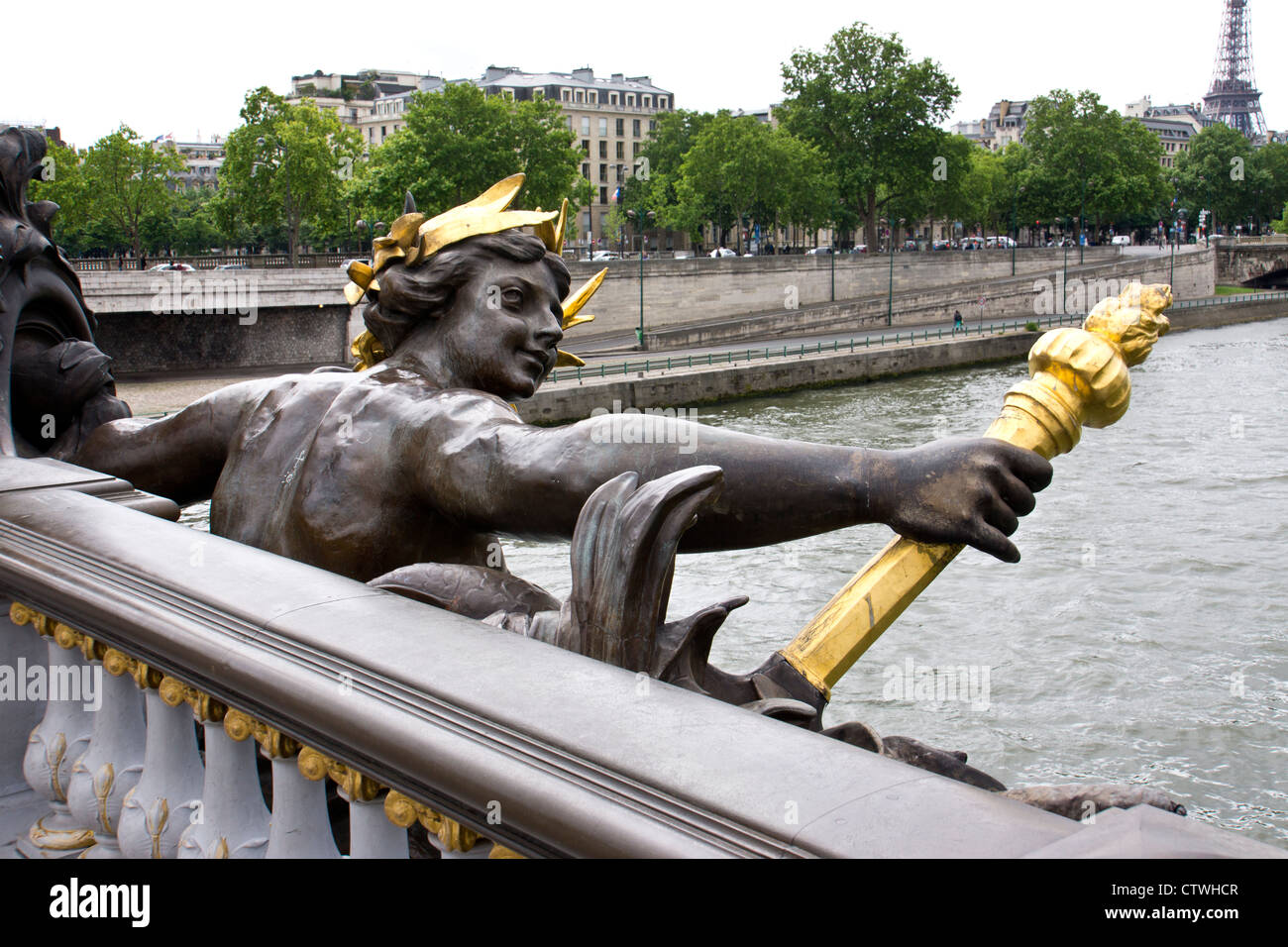 statue on the Bridge of Alexander III in Paris crossing the Seine river Stock Photo