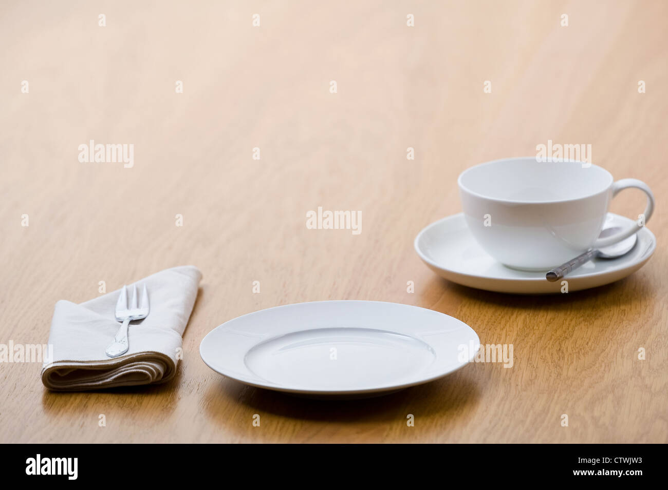 A table place setting, perhaps for afternoon tea and cake. Stock Photo