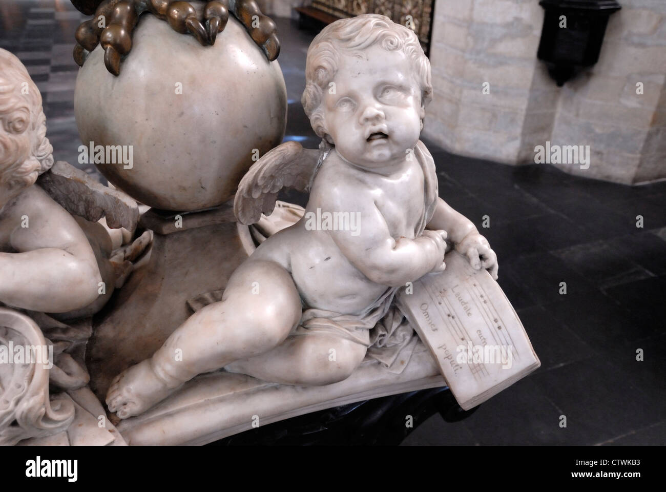 Brussels, Belgium. Church of Notre Dame de La Chapelle (13thC; Romanesque / Gothic) Cherub holding music Stock Photo