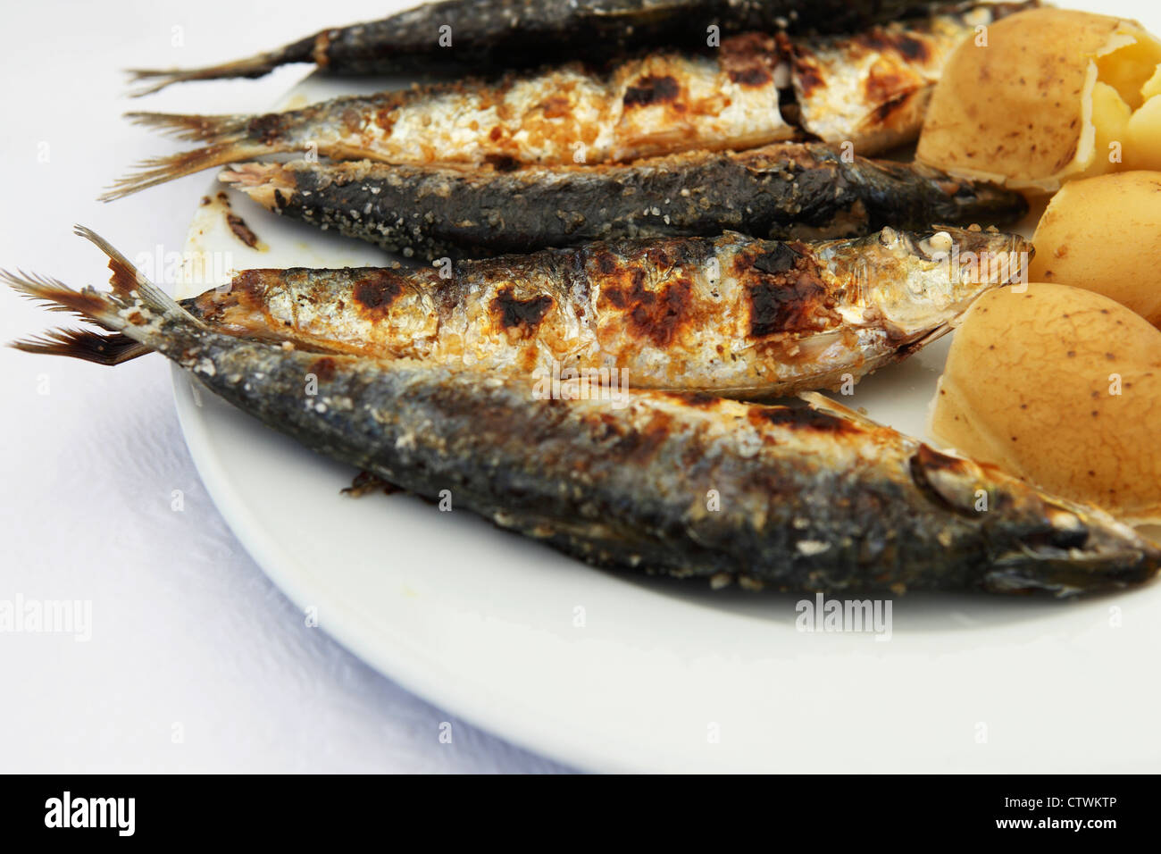 Grilled sardines are served on a plate in Peniche, Portugal. Stock Photo