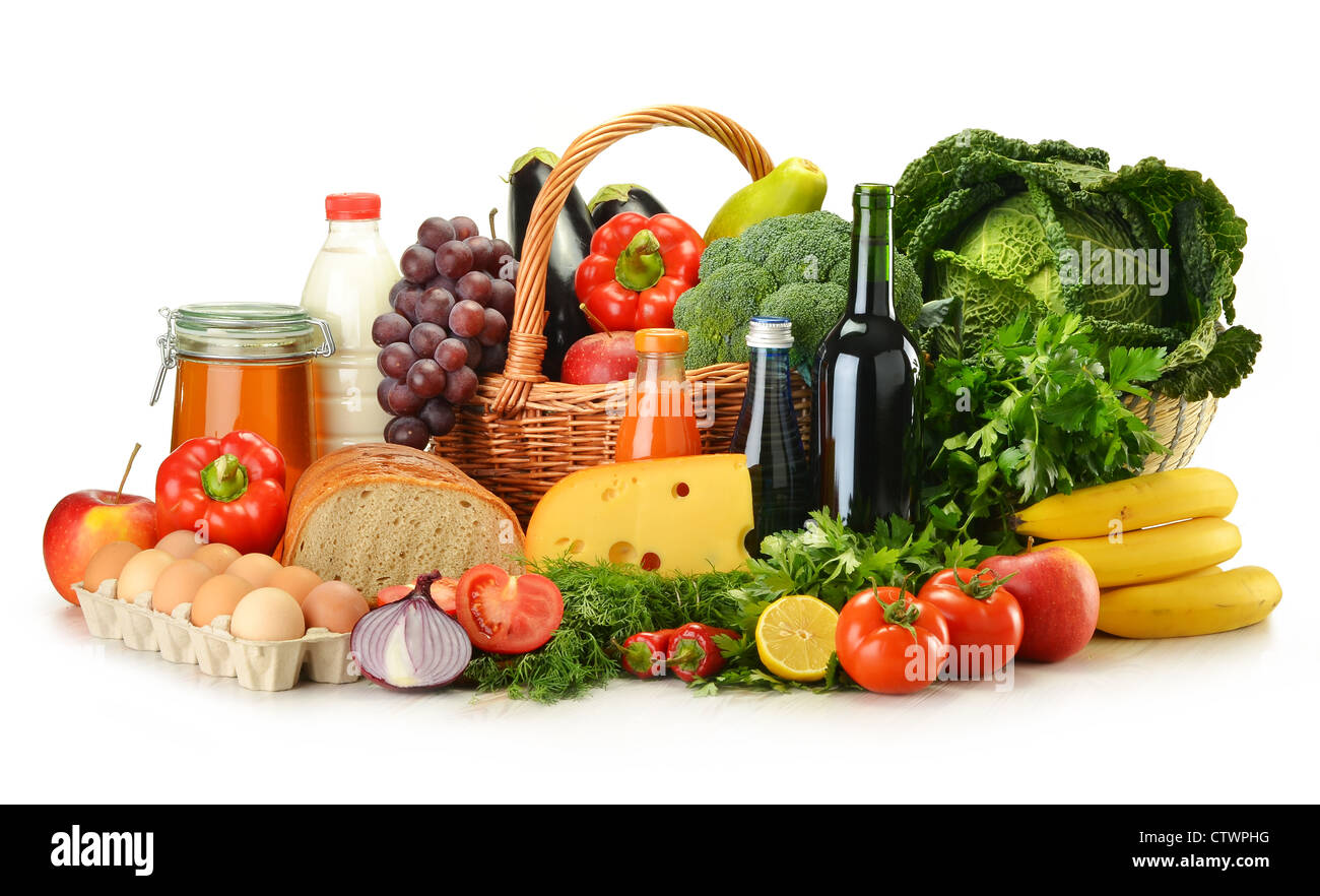 Groceries in wicker basket including vegetables, fruits, bakery and