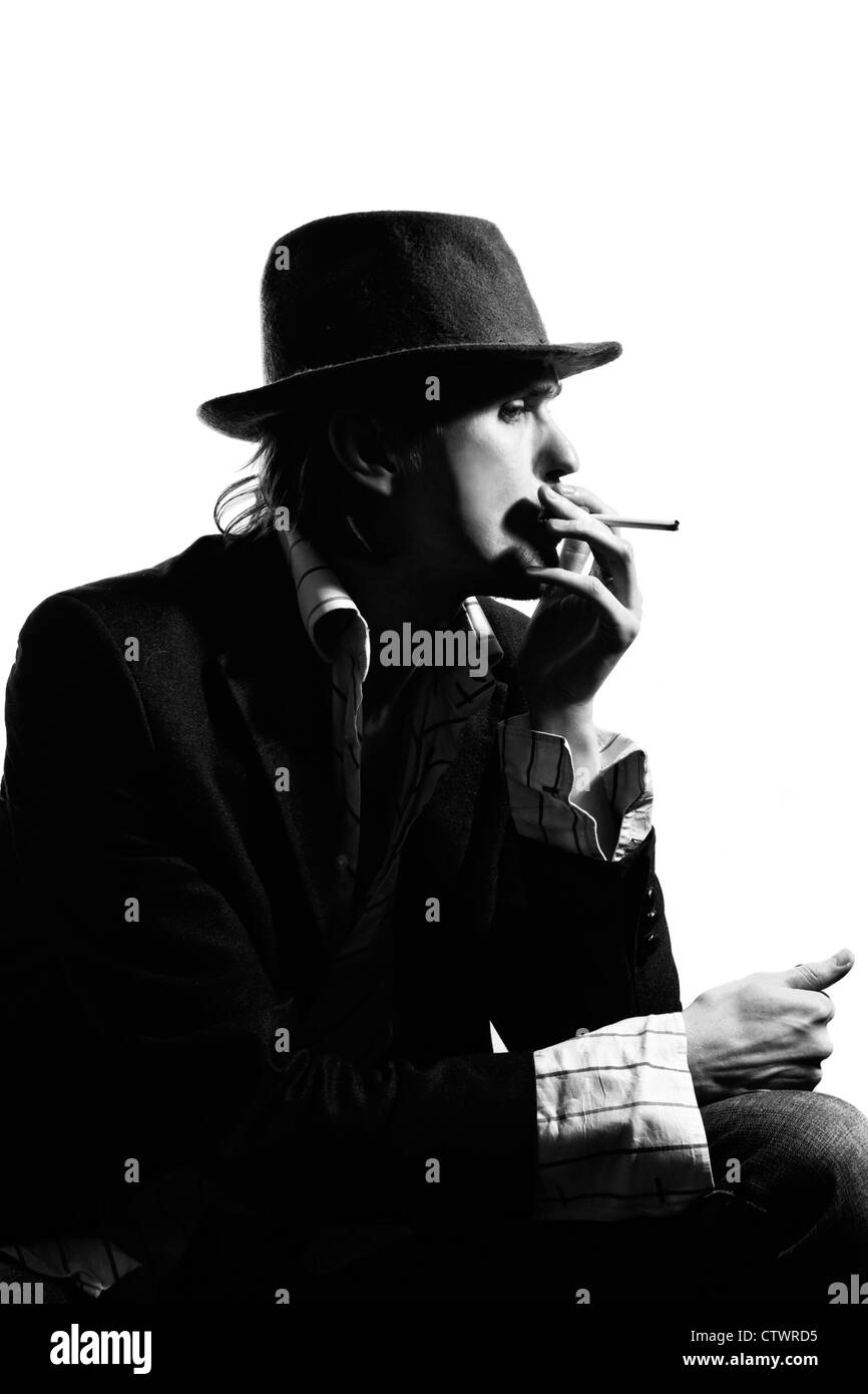 Portrait of young man wearing a hat with a cigarette on a white background. Retro style Stock Photo