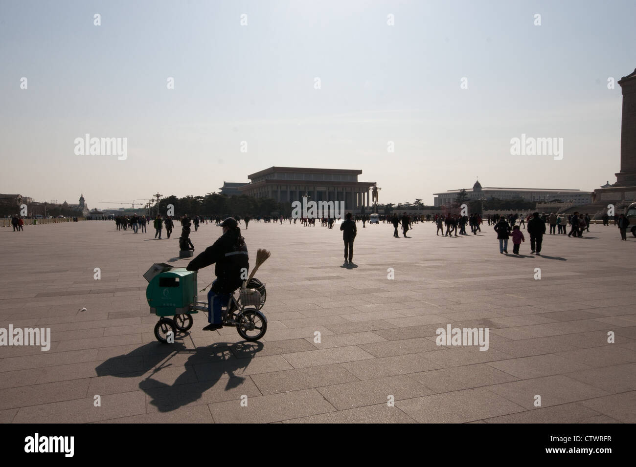 Silhouette of a cleaner cycling through Tiananmen Square Stock Photo