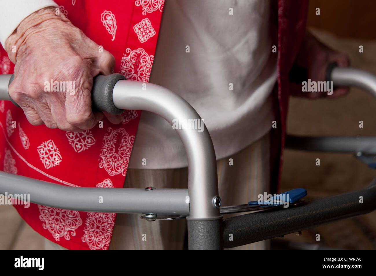 Elderly woman walking with the aid of a walker Stock Photo - Alamy