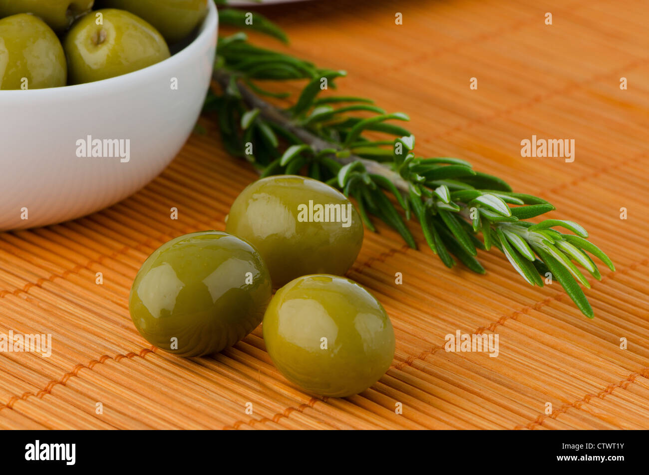 Green olives in a white ceramic bowl and oil decanter set Stock Photo ...