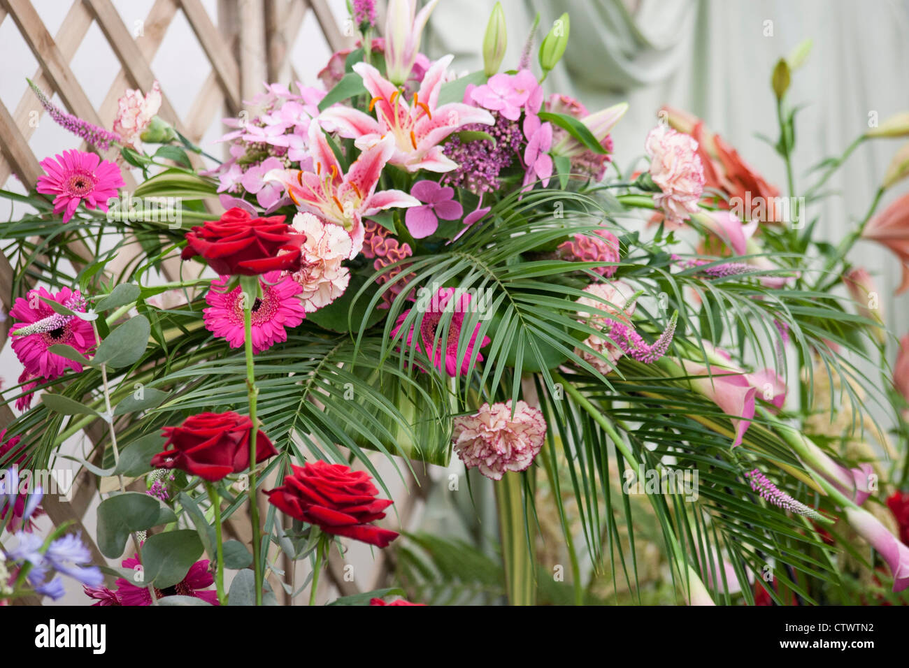 a floral display using roses,gerbera,lilies,palm leaves,hebe,hydrangea and a callo lily Stock Photo