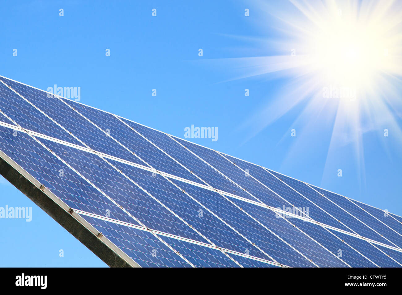 Solar panel against blue sky with sun sunlight Stock Photo