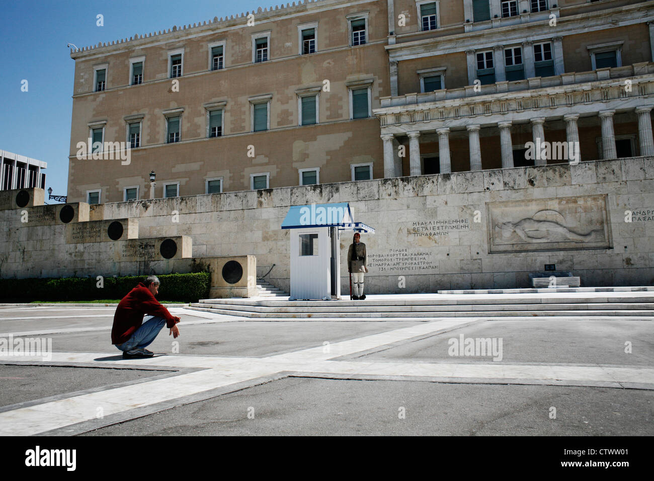 Homeless man in front of the Greek Parliament. Syntagma Square, Athens ...