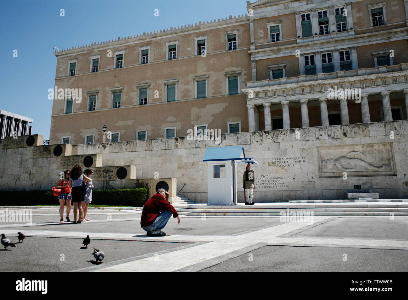 Homeless man in front of the Greek Parliament. Syntagma Square, Athens ...