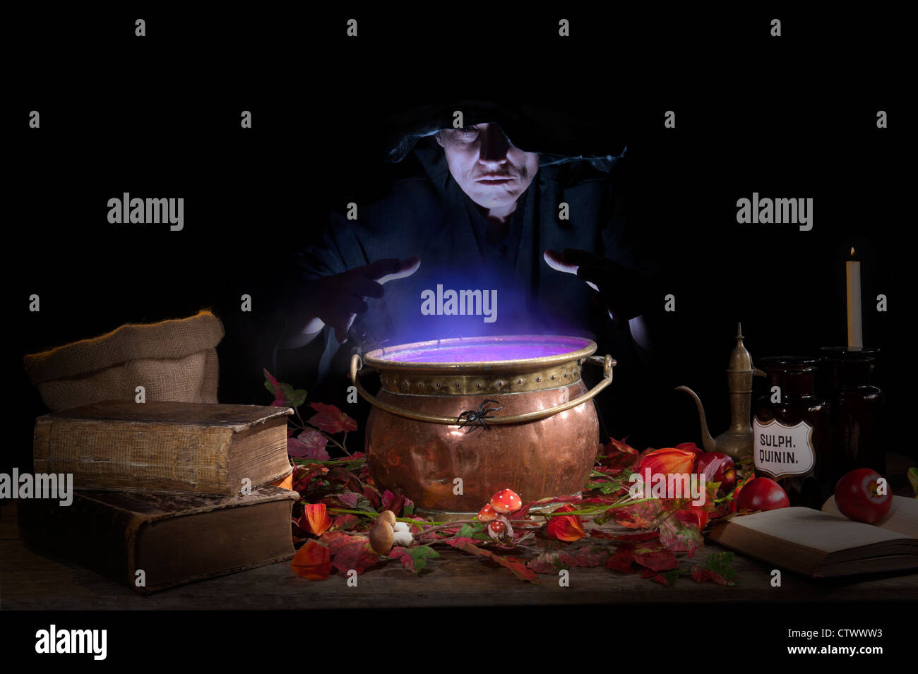 halloween making a potion in a copper cauldron Stock Photo