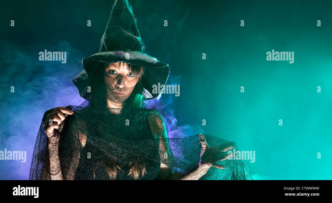 Halloween witch, green and blue smoke background Stock Photo