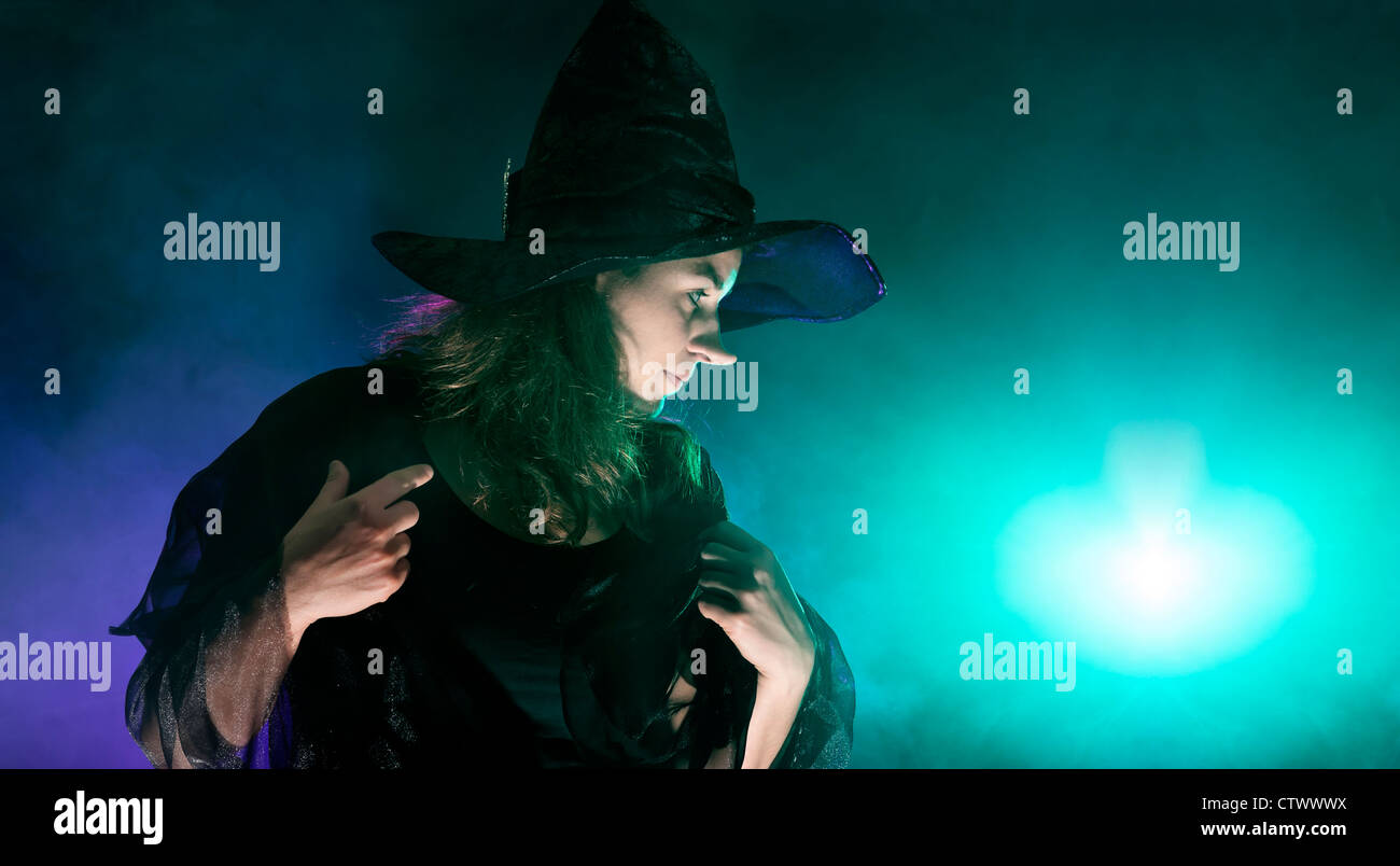 Halloween witch on smoky green and purple background Stock Photo