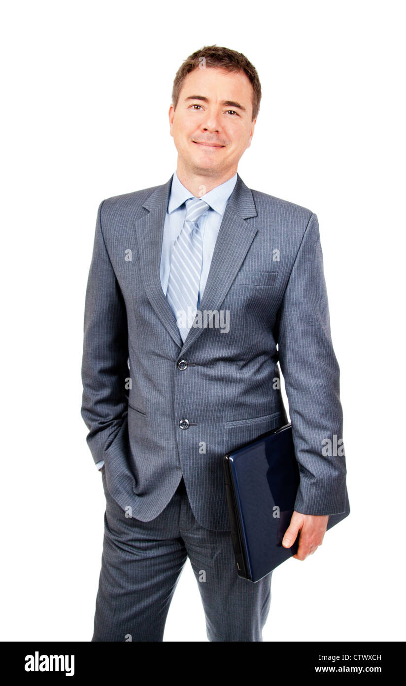 Relaxed business man standing with laptop in hand Stock Photo