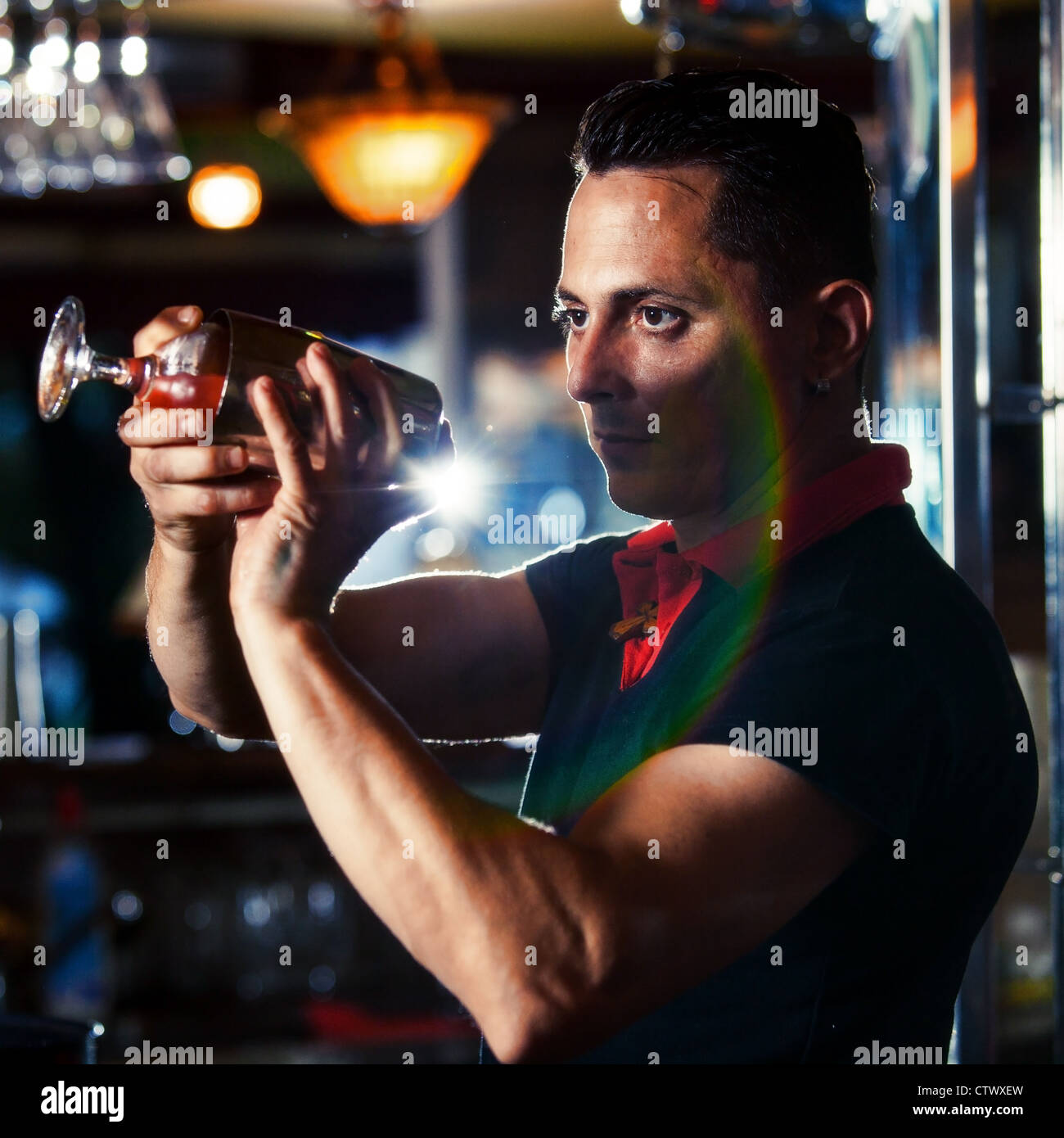 Young bartender with cocktail Stock Photo