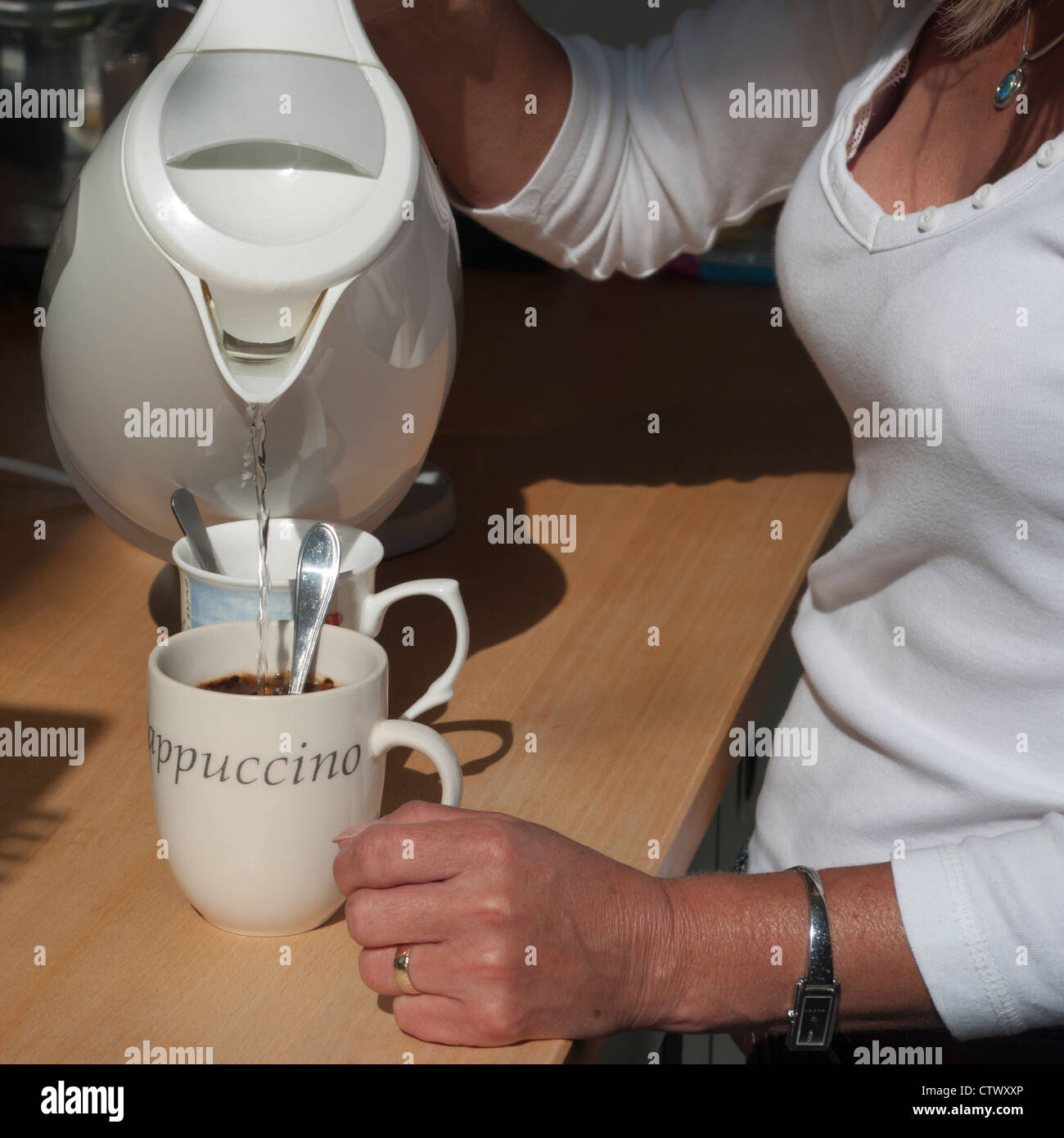 Woman Person Making A Cup Of Coffee Pouring Boiling Water Into a Mug