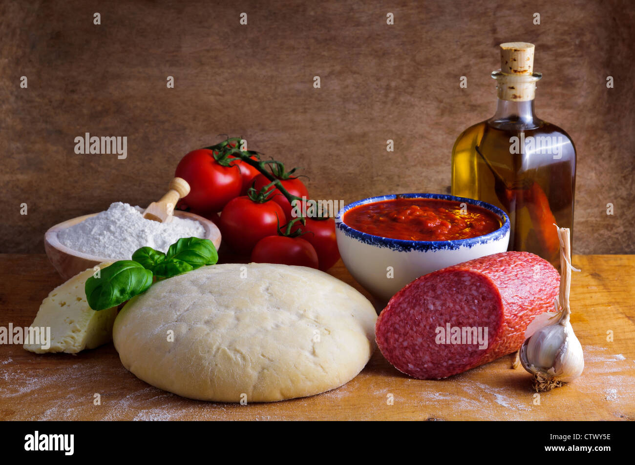 Still life with traditional homemade salami pizza ingredients and dough Stock Photo