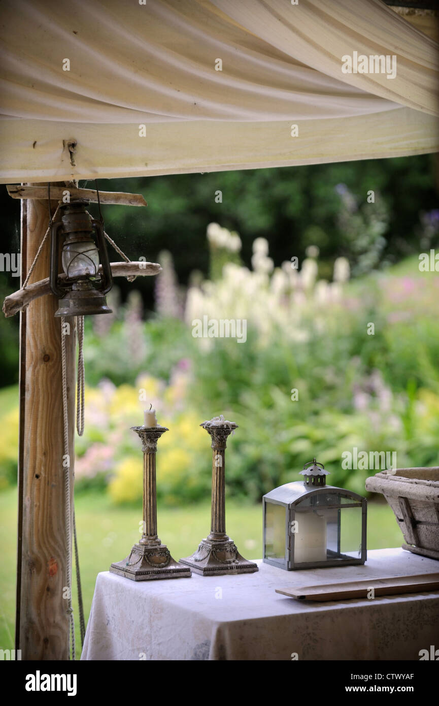Brass candlesticks on an outdoor dining table UK Stock Photo