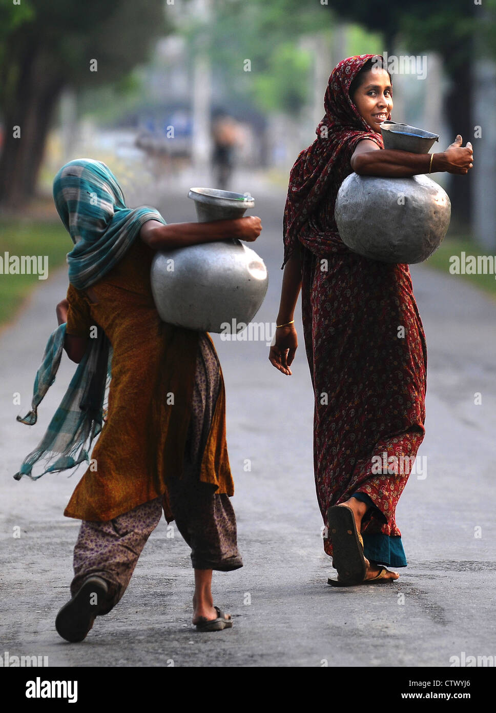 Women carrying drinking water in Chandpai Bangladesh Stock Photo