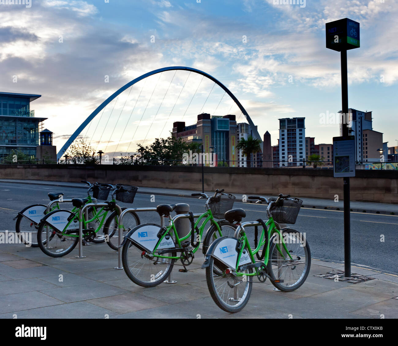 NE1 Hire Bikes on the Quayside in Newcastle with the Millennium Bridge in the background Stock Photo