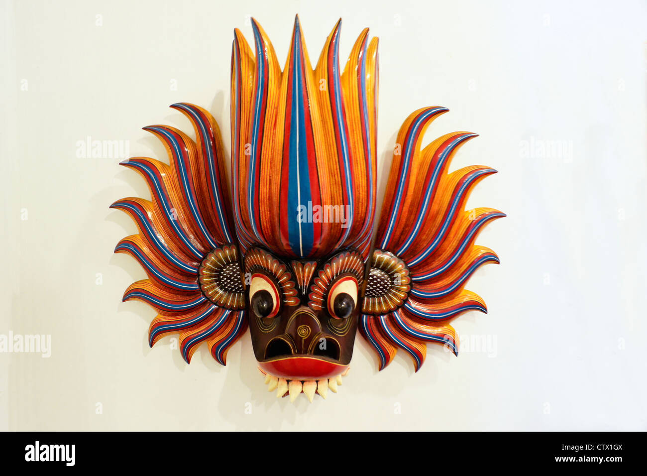 Carved wood dance mask (fire) of Sri Lanka Stock Photo