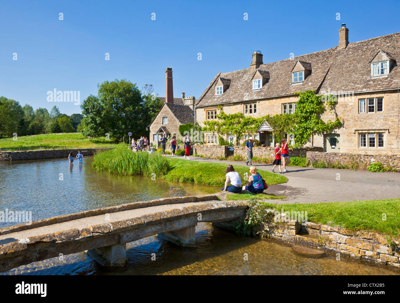 Cotswolds village of Lower Slaughter village with a stone bridge over the river Eye and mill in the cotswolds Gloucestershire England UK GB  Europe Stock Photo