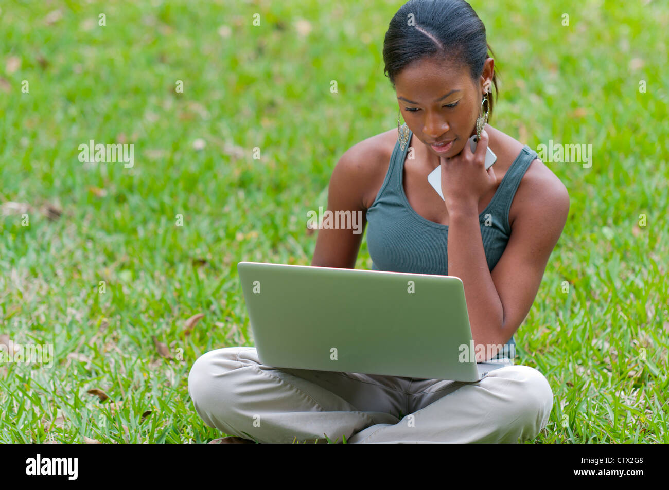African American woman student studying outdoors using a laptop Stock ...