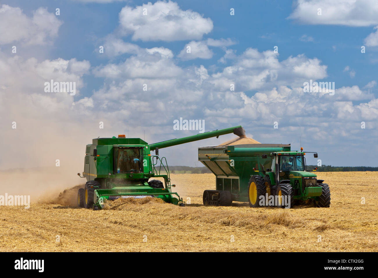 A John Deere combine harvesting wheat near Notre Dame de Lourdes, Manitoba, Canada. Stock Photo