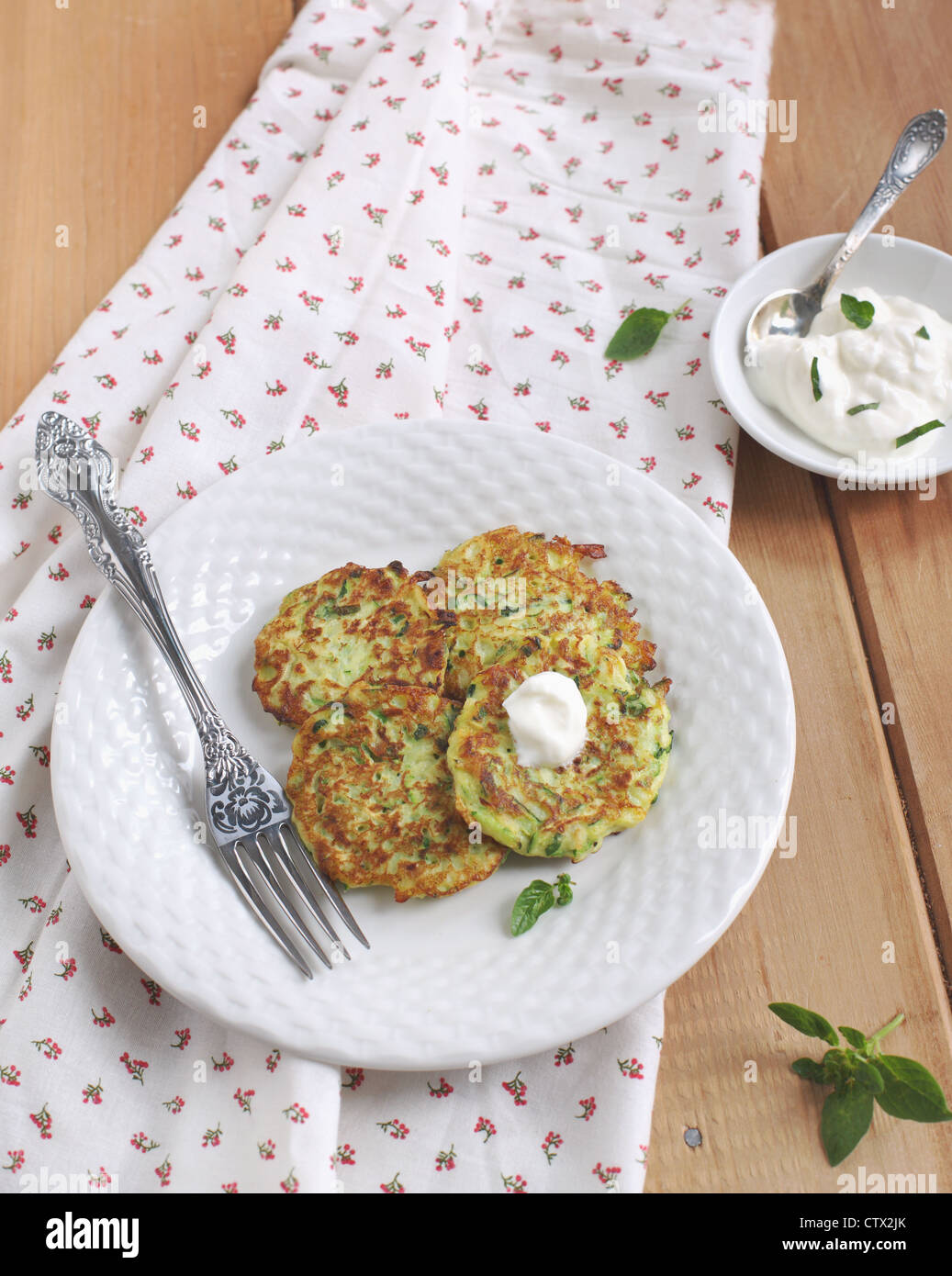 Zucchini fritters with yogurt sauce Stock Photo Alamy