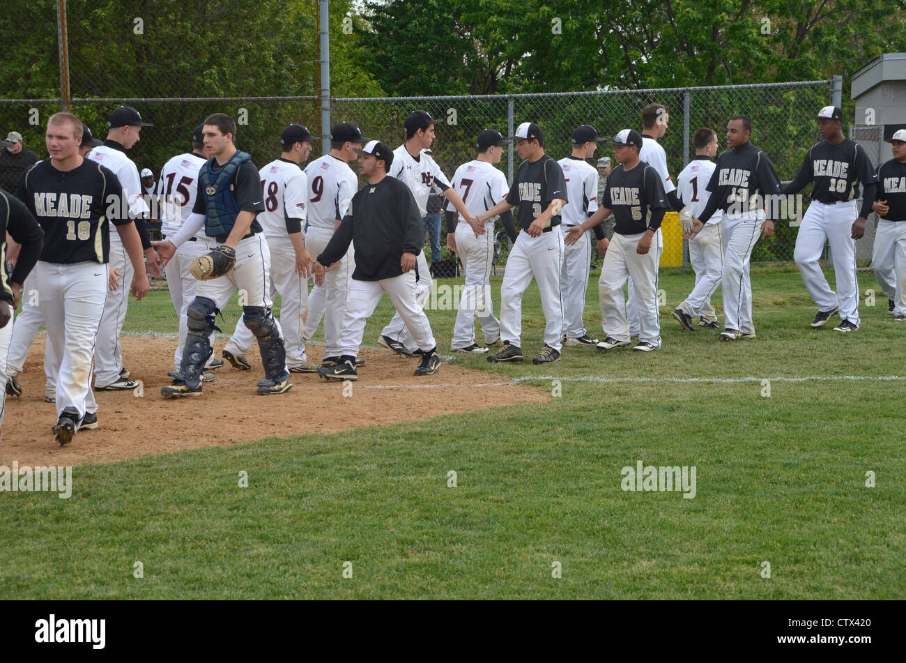 high school baseball players congratulate opponents for a job well done Stock Photo