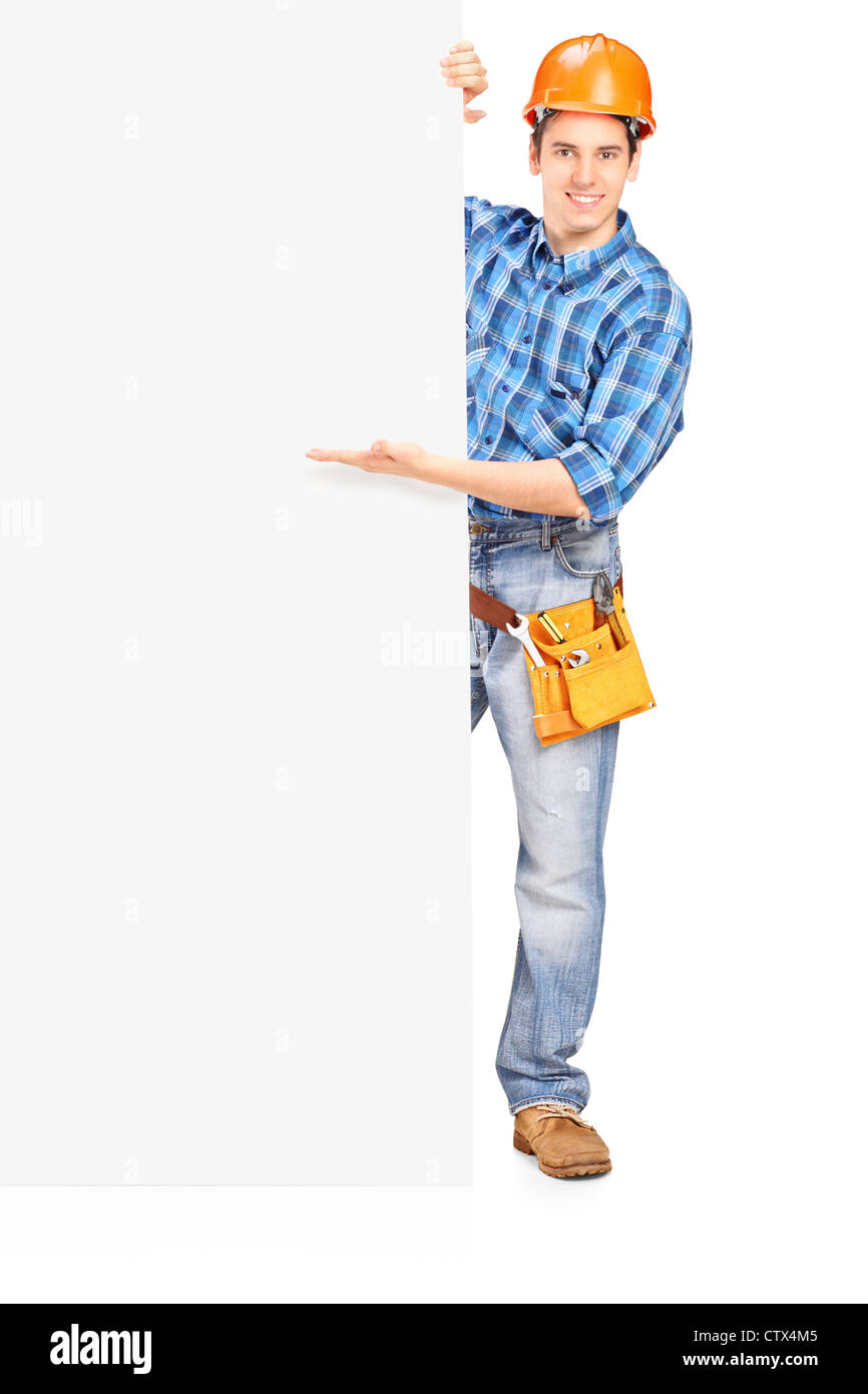 Full length portrait of a construction worker with helmet posing behind ...
