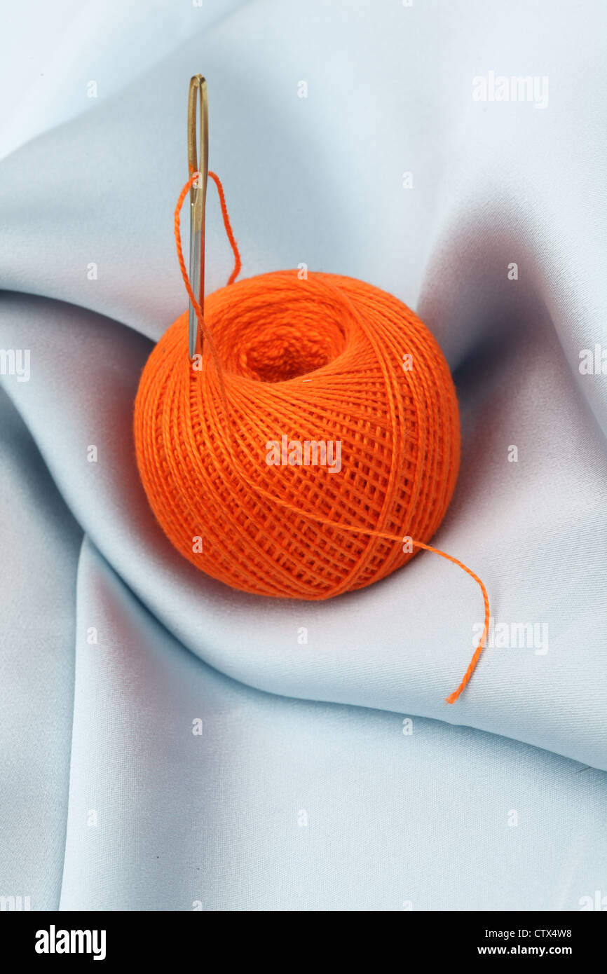 thread ball on textile Stock Photo - Alamy