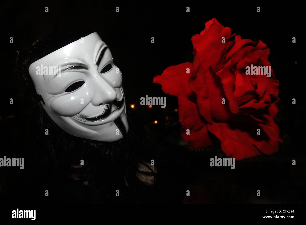 A member of the group Anonymous wearing Guy Fawkes mask during Cost of Living protest in Tel Aviv Israel. The Guy Fawkes mask is a well-known symbol for the online hacktivist group Anonymous used in anti-government and anti-establishment protests around the world. Stock Photo