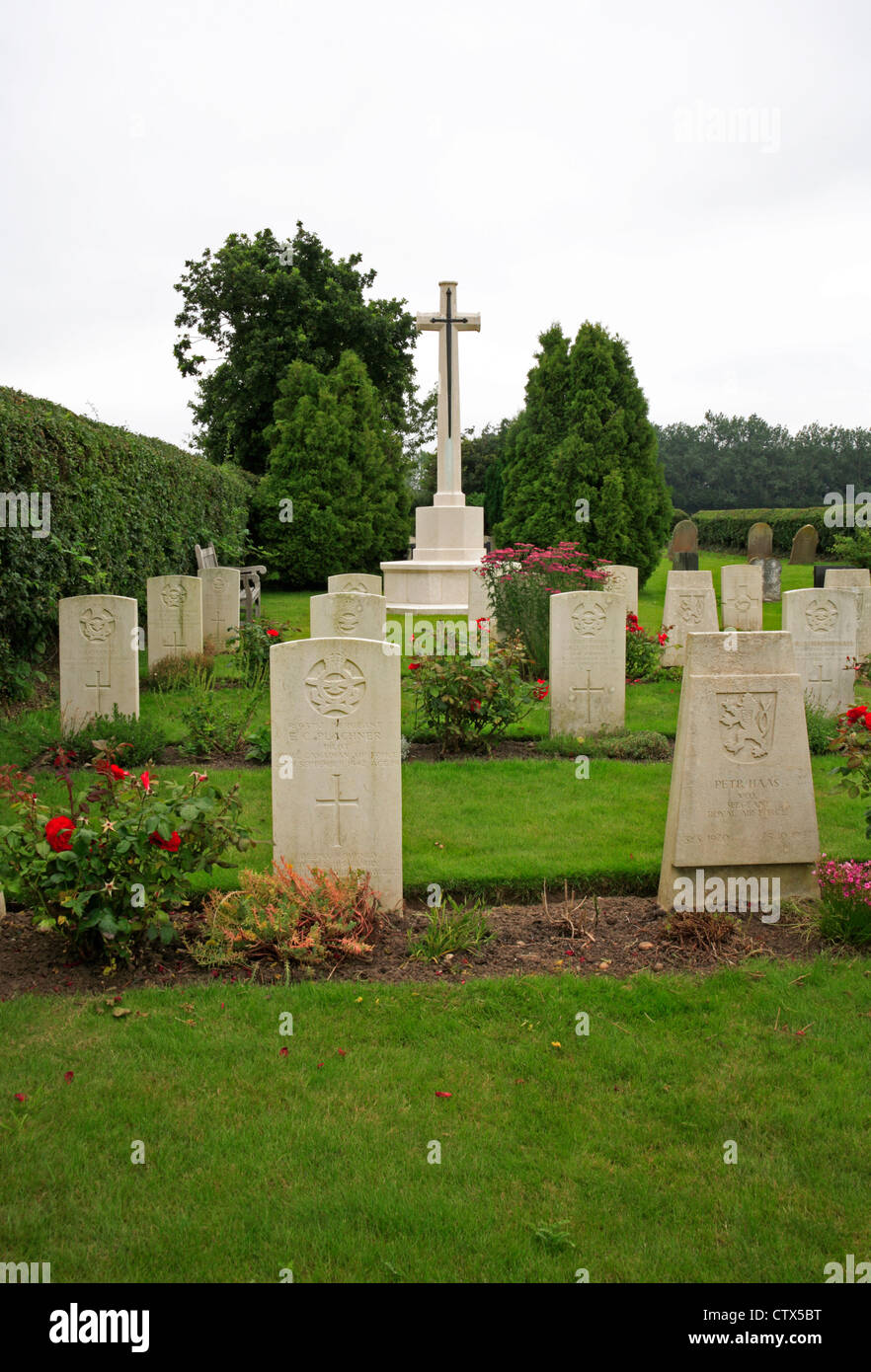 A view of the war graves plot and memorial cross for service personnel at Scottow Cemetery, Norfolk, England, United Kingdom. Stock Photo