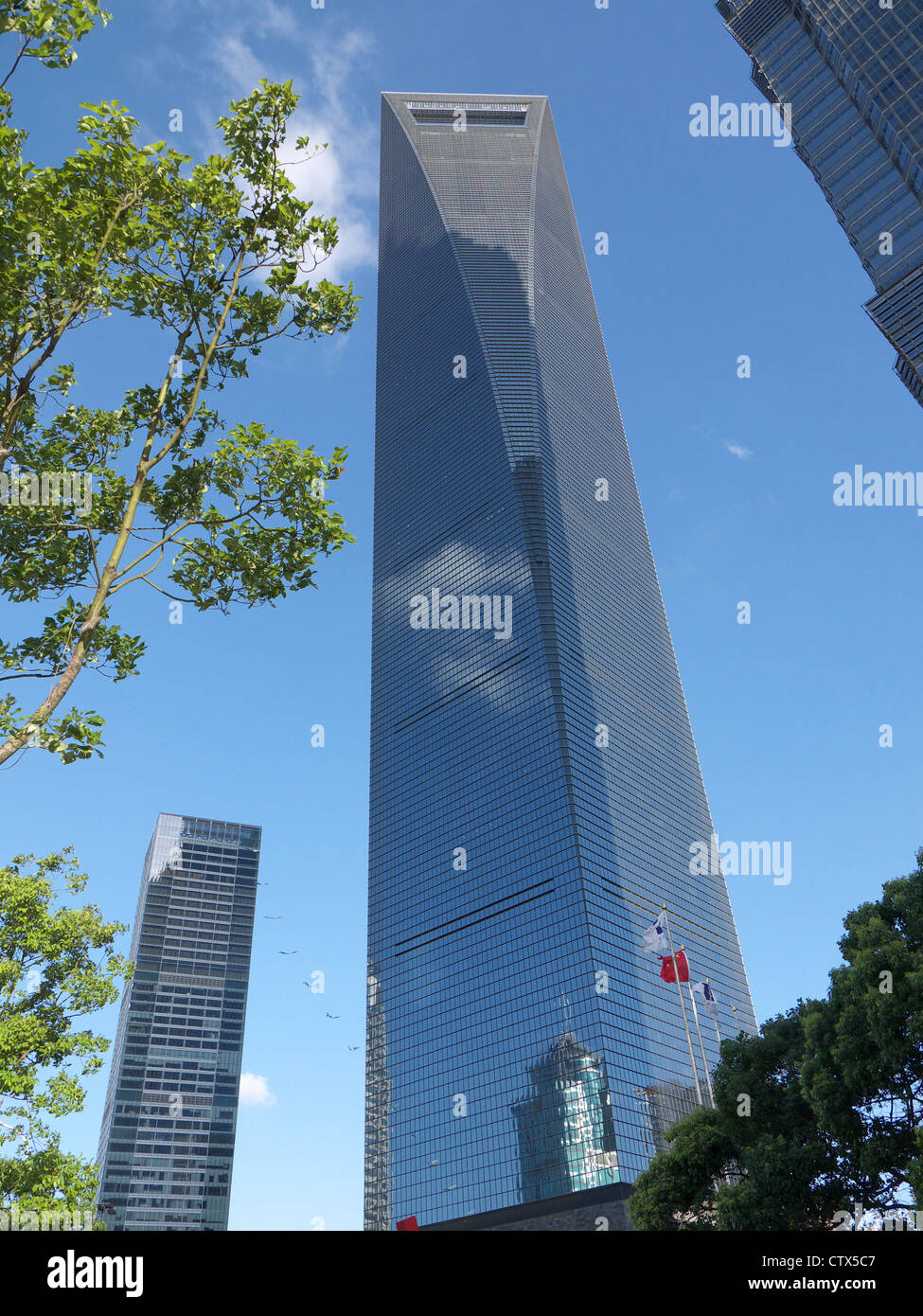 View looking up at the Shanghai World Finance Centre SWFC from Century Avenue far below Stock Photo