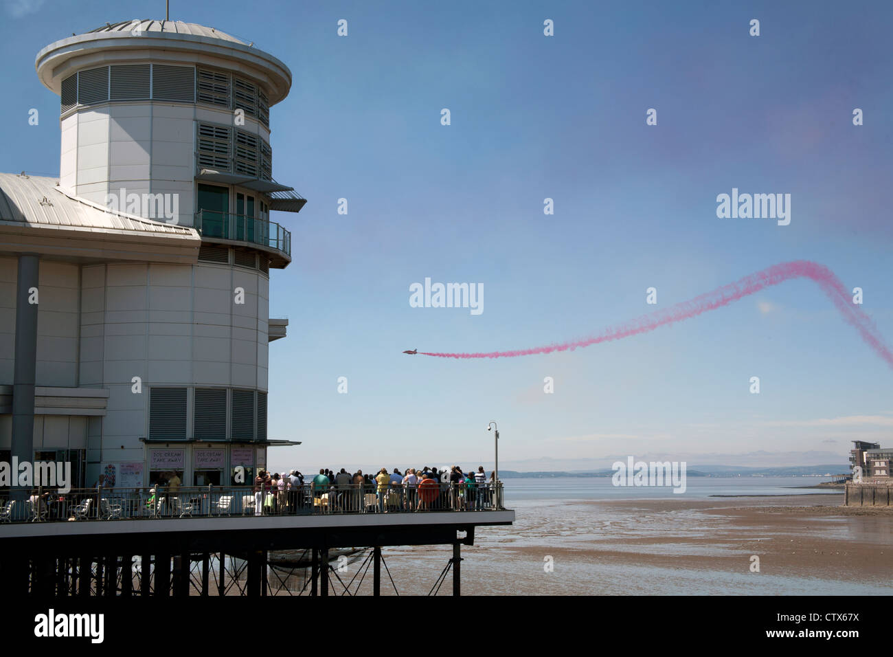 People watching the Red Arrows flying over the pier as part of the Grand Pier Air Show Weston Super Mare Somerset UK Stock Photo