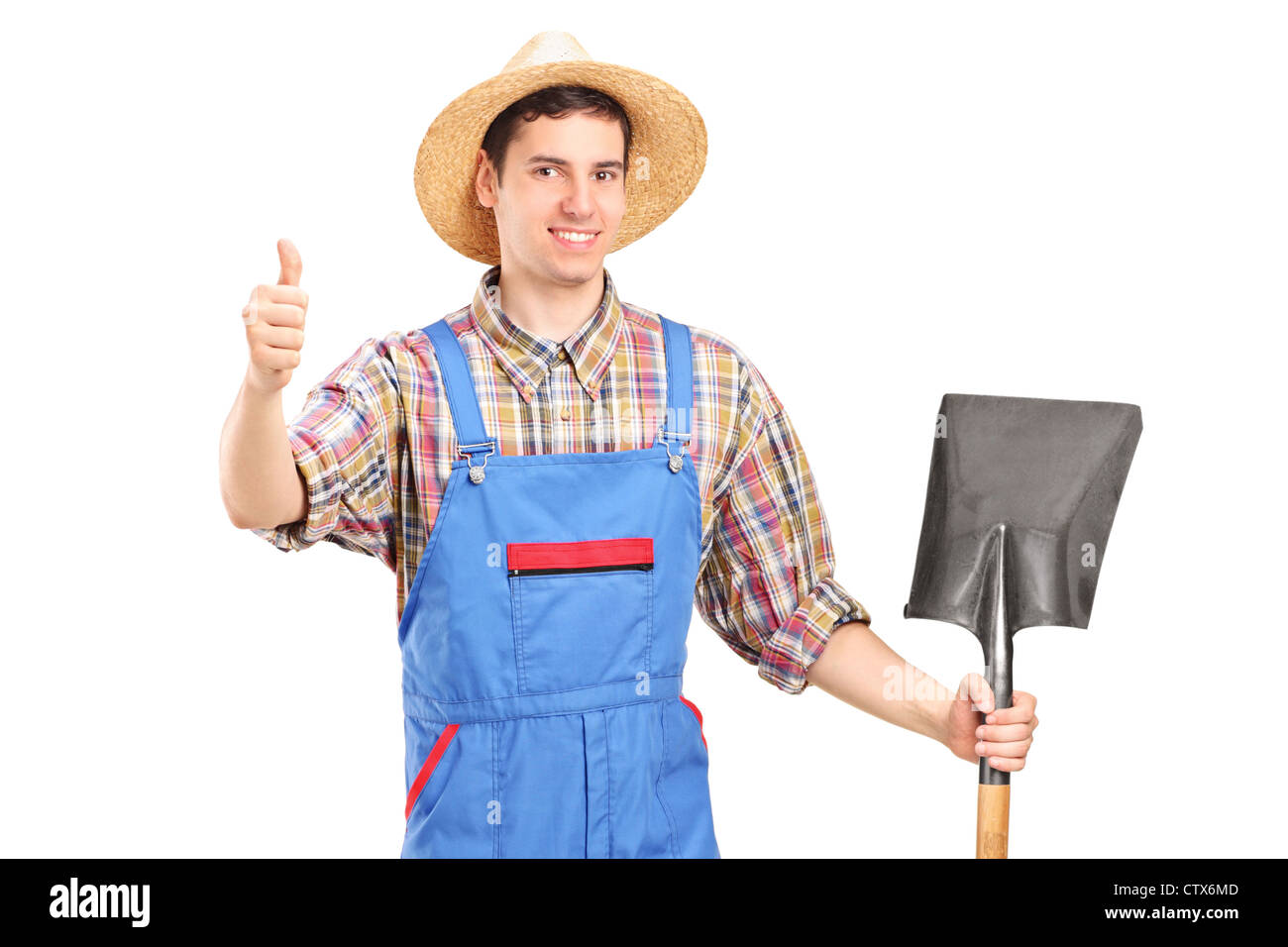 A male agricultural worker holding a shovel and giving a thumb up ...