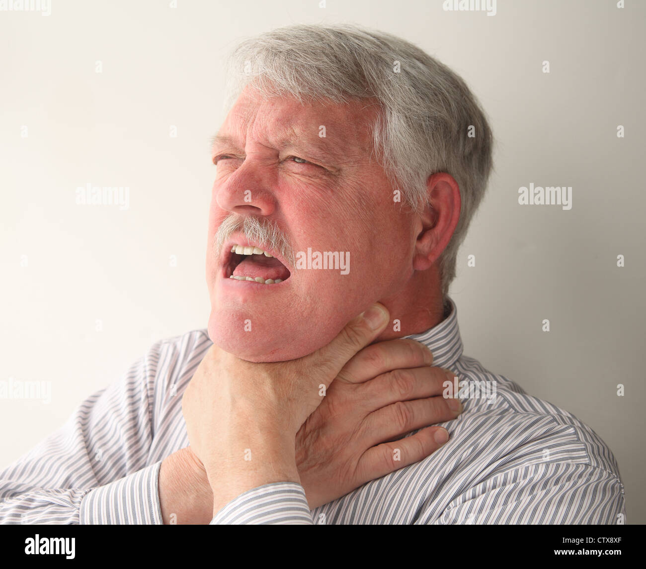 a senior man with food stuck in his throat Stock Photo