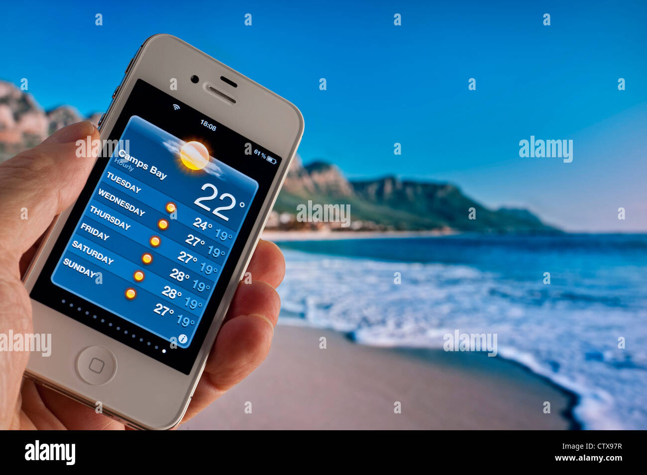 Apple iPhone 4s displaying 22C morning sun on weather forecast application at Camps Bay Capetown South Africa Stock Photo