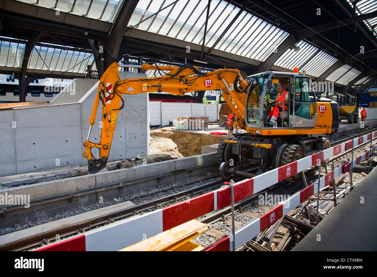 A rail mounted excavator in Zurich's main train station Stock Photo Alamy