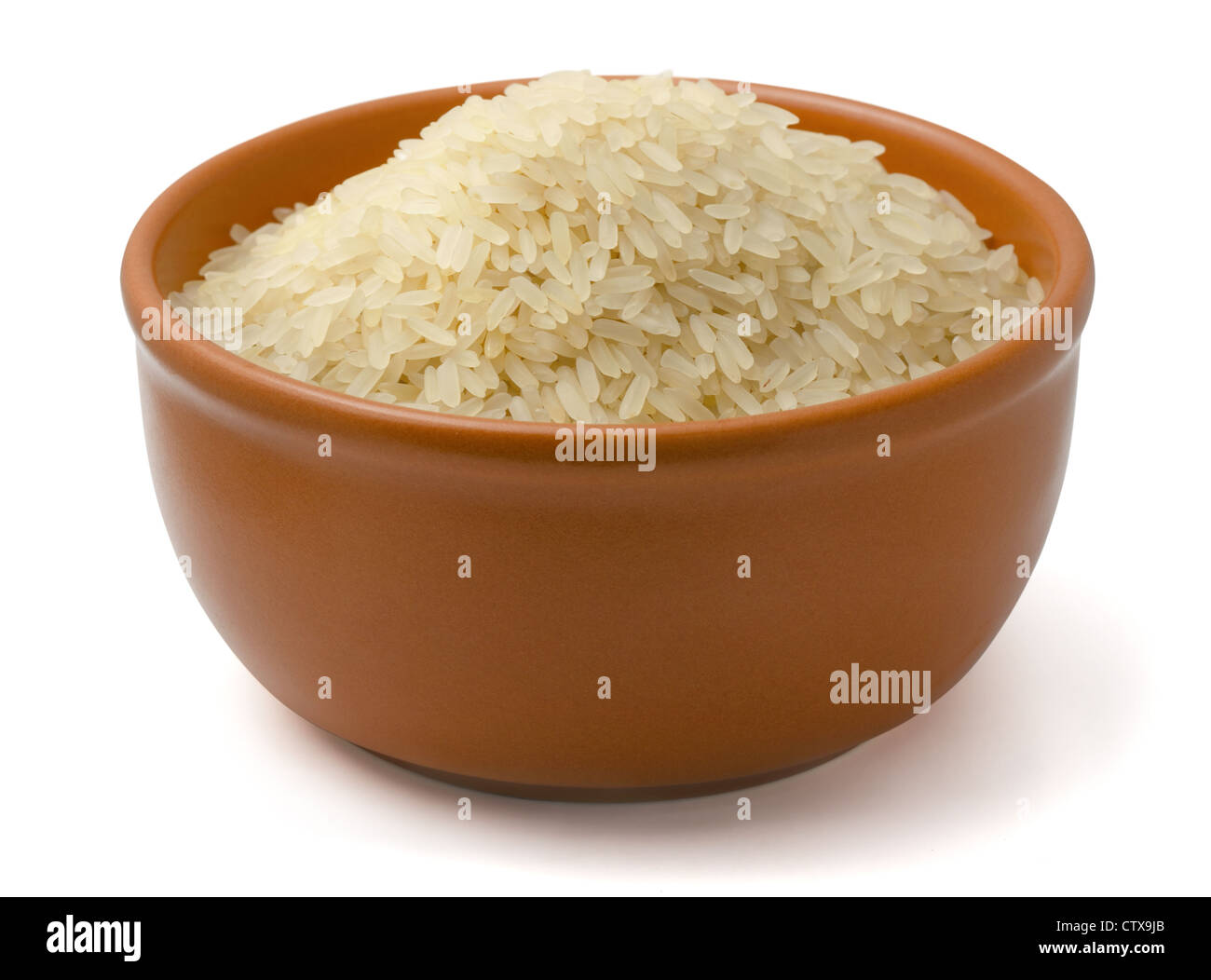 Clay bowl full of parboiled rice isolated on white Stock Photo