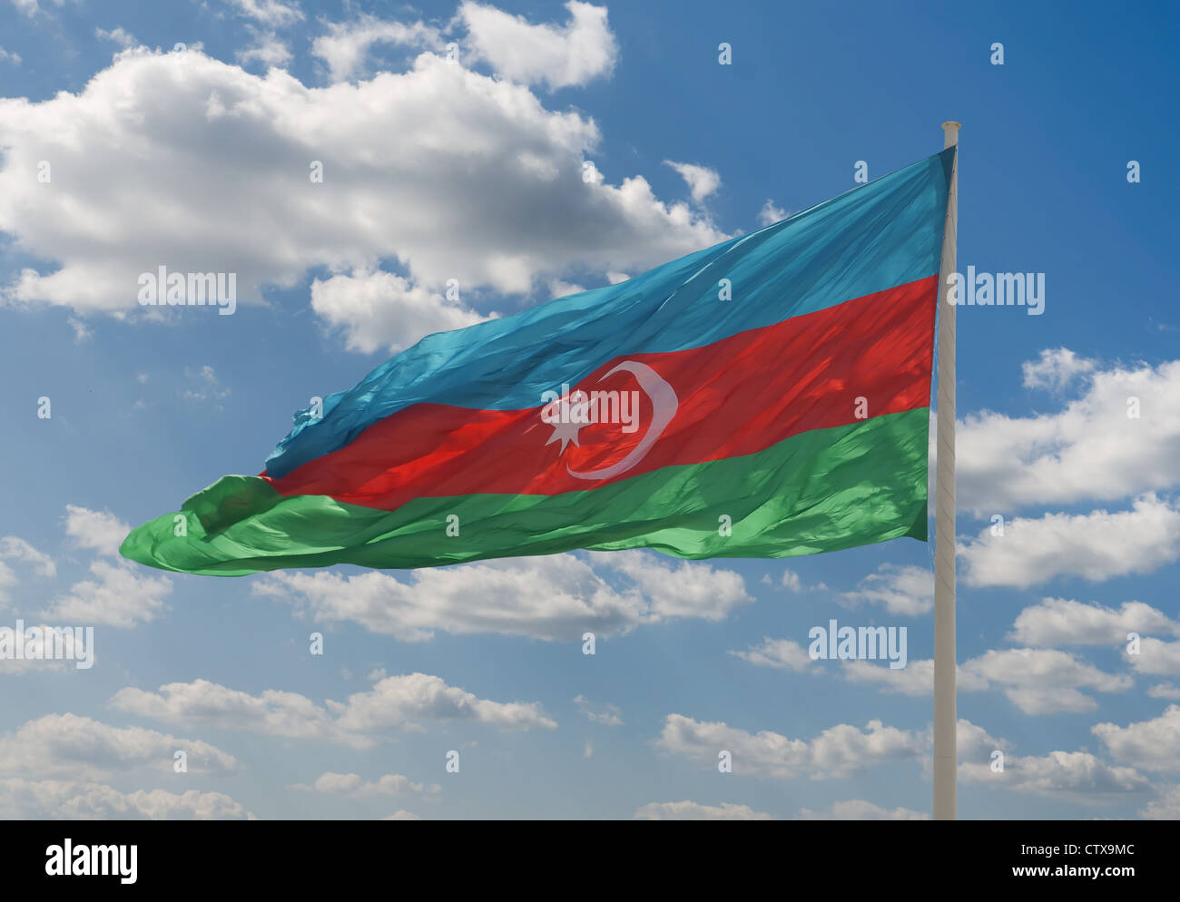 National flag of Azerbaijan against blue sky Stock Photo
