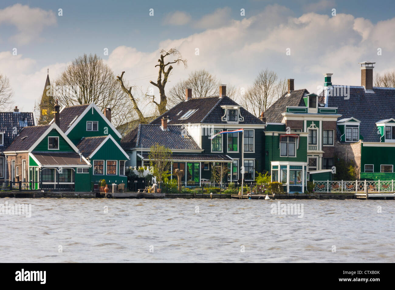 Houses on the Zaans River across from Zaanse Schans National Park and Museum in North Holland, The Netherlands. Stock Photo